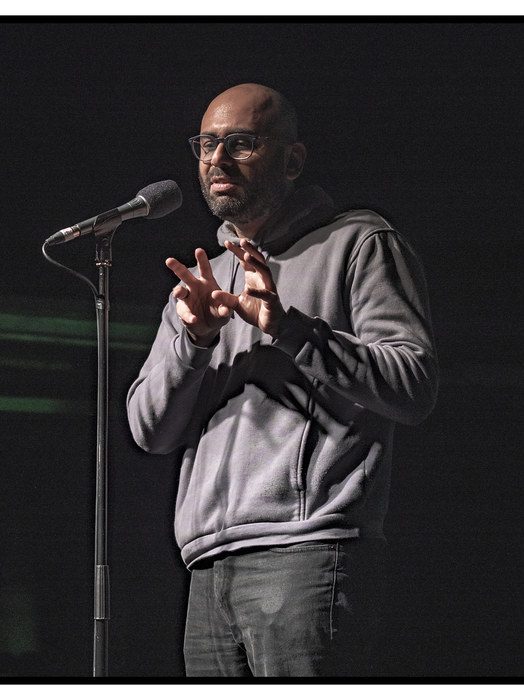 Akshay gajria performing at the Moth StorySLAM